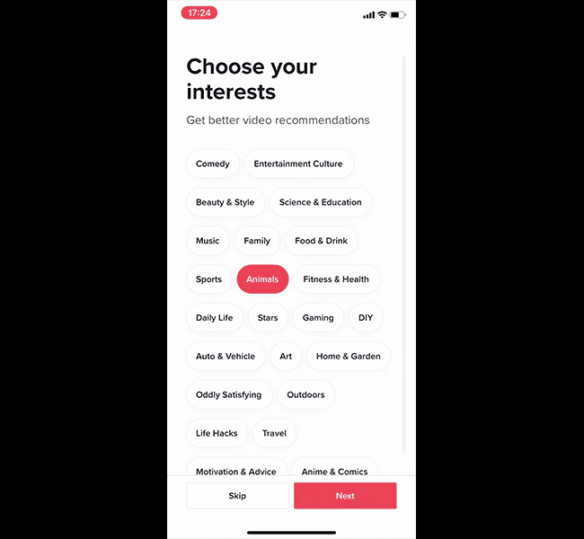 TikTok Choose your interests screen with topic chips, Animals selected, and Skip and Next buttons