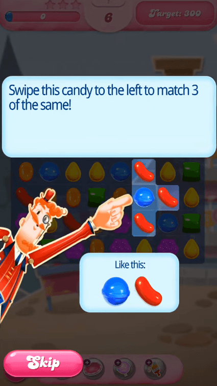 Candy Crush mascot pointing at a highlighted candy under the instruction to swipe it left and match three