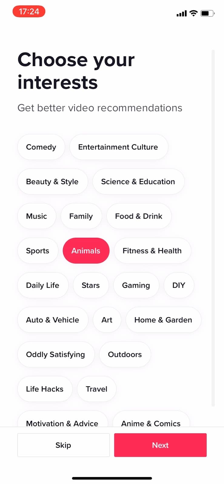TikTok Choose your interests screen with topic chips, Animals selected, and Skip and Next buttons